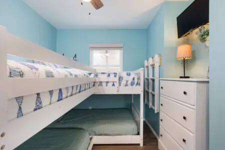 Your kiddos are gonna lose their minds over this cheerful nautical nook with its perfectly stacked bunks.