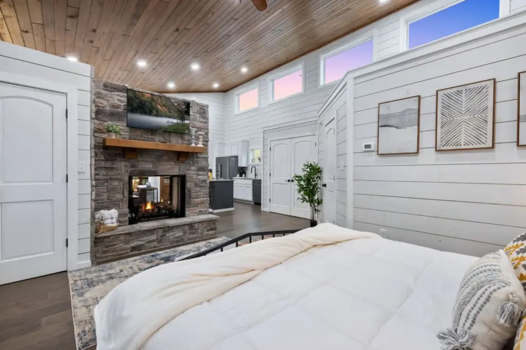 There's something about a bedroom that has its own fireplace, wet bar, and those sweeping windows that makes you realize you never actually need to leave the room—but you'll want to anyway, just to see what else this place has in store.
