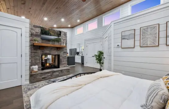 There's something about a bedroom that has its own fireplace, wet bar, and those sweeping windows that makes you realize you never actually need to leave the room—but you'll want to anyway, just to see what else this place has in store.