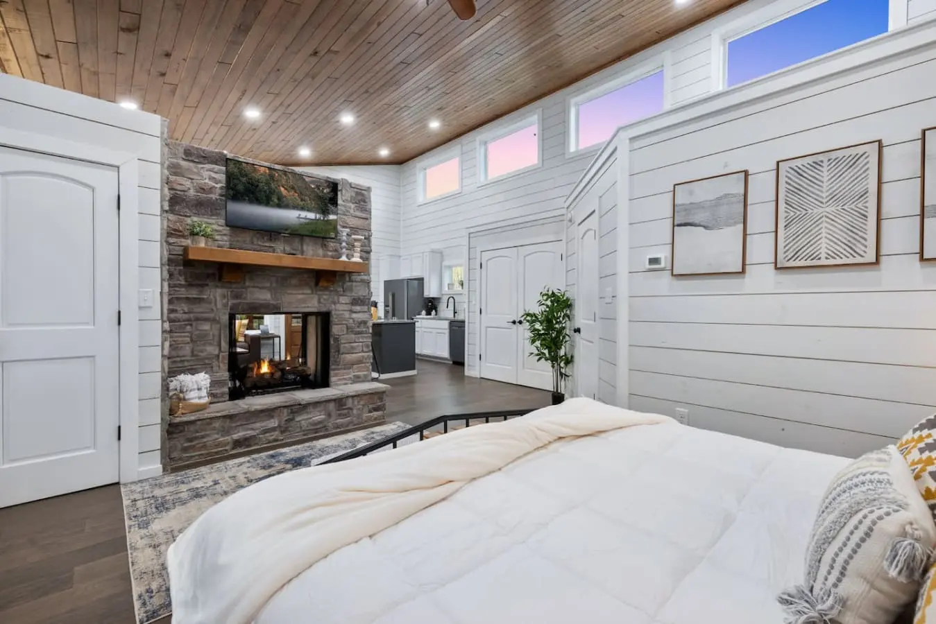There's something about a bedroom that has its own fireplace, wet bar, and those sweeping windows that makes you realize you never actually need to leave the room—but you'll want to anyway, just to see what else this place has in store.
