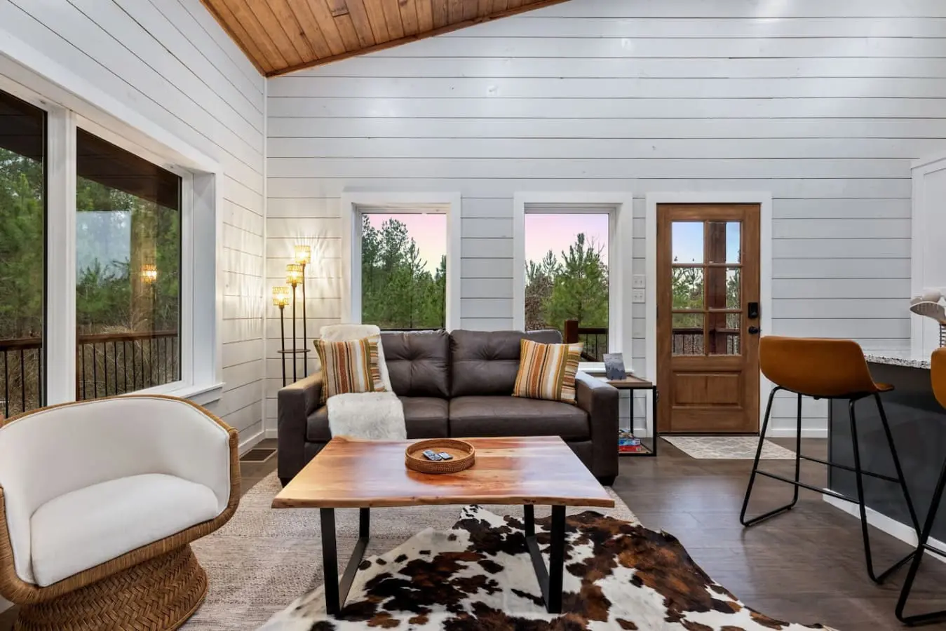 Step inside where floor-to-ceiling windows frame the forest like living artwork, and you've got this serene modern space all to yourself—it's the kind of room that makes you want to just sit and breathe for a while.