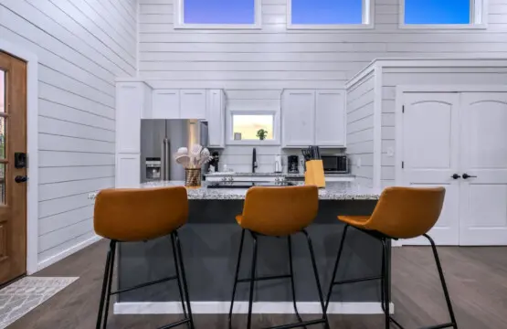 Slide onto one of those cognac-colored stools, lean against the granite countertop, and realize this kitchen island is basically the unofficial headquarters for the whole trip.