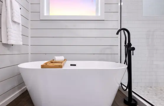 Sink into this freestanding soaking tub with the window framing that soft sky above, and you'll understand why soaking in hot water while gazing at the forest feels like the closest thing to pure peace you've ever experienced.