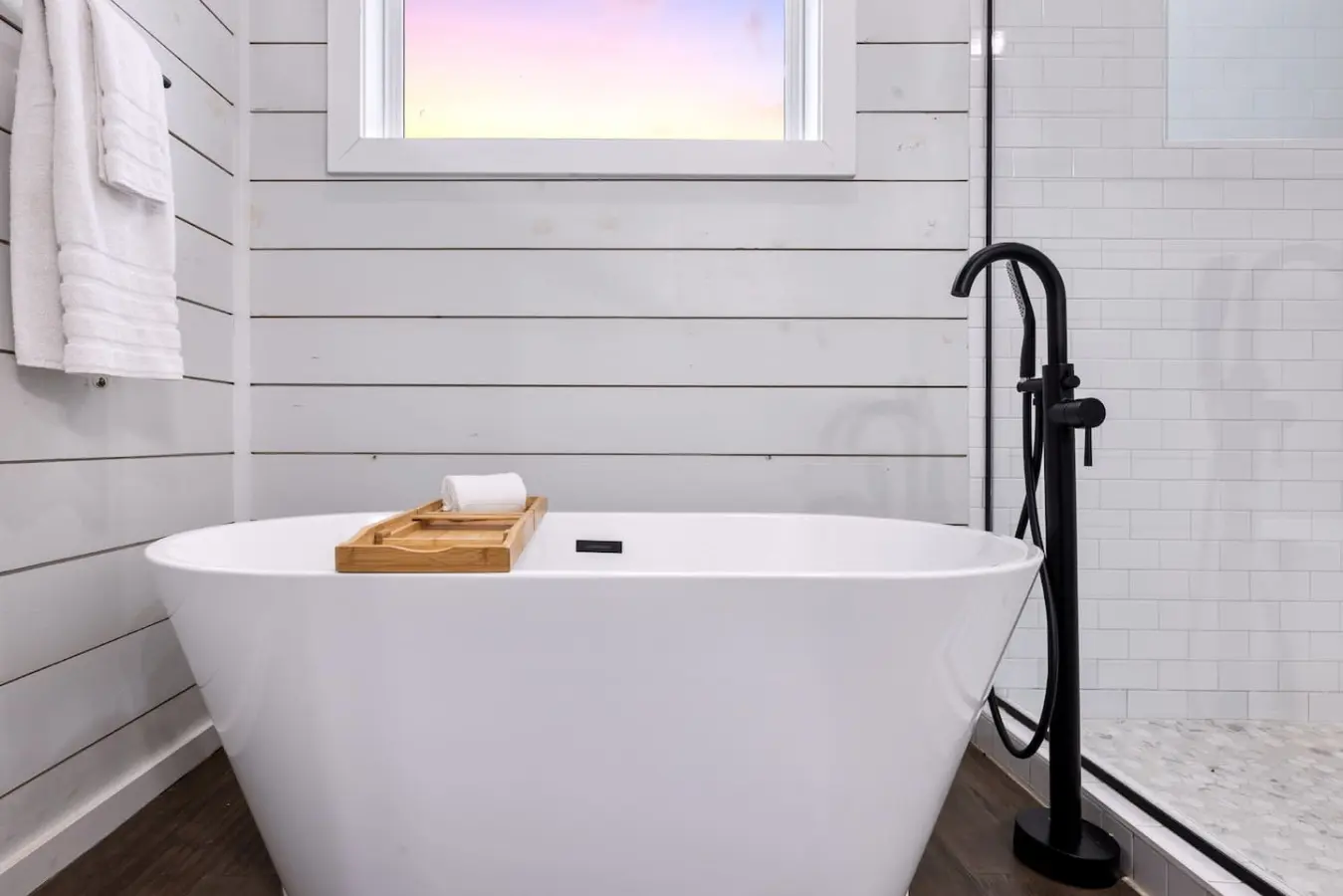 Sink into this freestanding soaking tub with the window framing that soft sky above, and you'll understand why soaking in hot water while gazing at the forest feels like the closest thing to pure peace you've ever experienced.