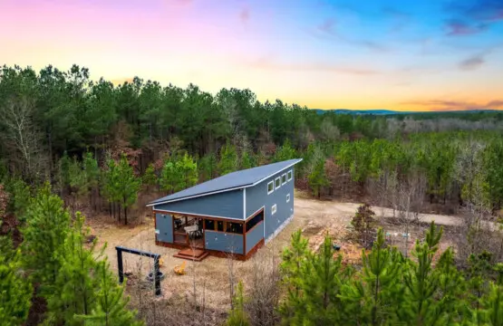 Tucked into a sprawling forest with nothing but trees and sky surrounding you, this modern cabin is basically your own private world where the sunset does the heavy lifting on the whole escape vibe.