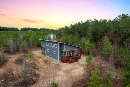 Perched alone in a sea of pines with nothing but forest in every direction, this modern cabin feels like you've finally cracked the code on what a real escape actually looks like.