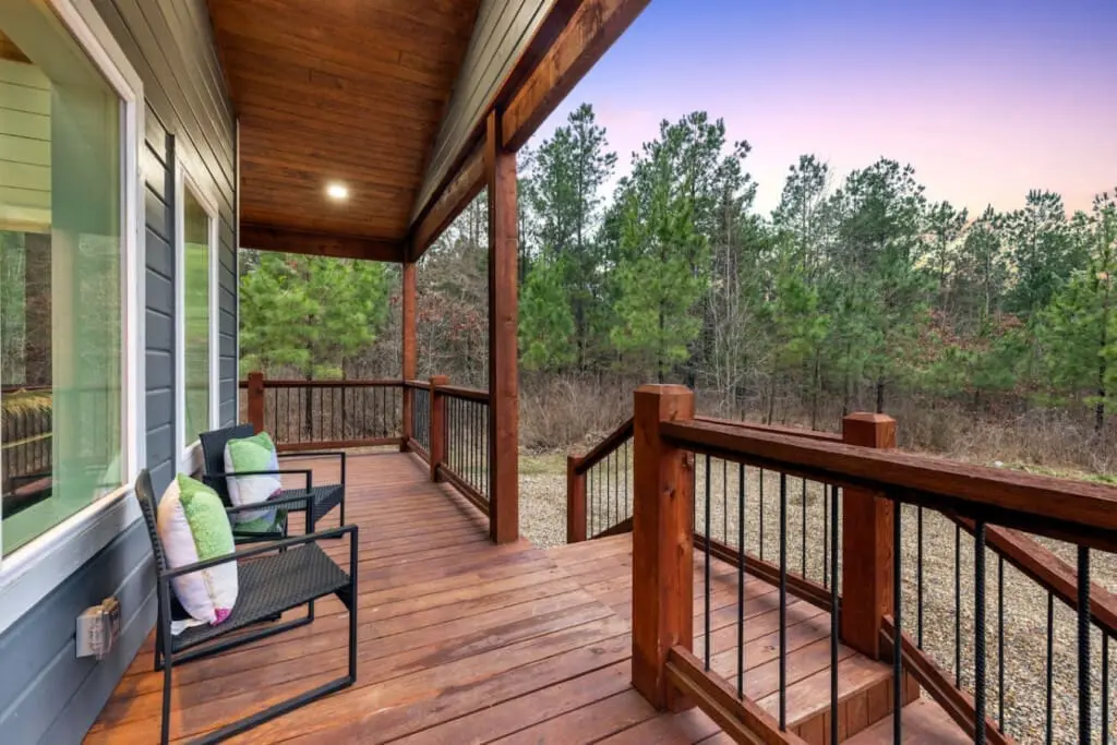 Settle into one of those cozy chairs on the covered porch, let the forest breathe around you, and discover that sometimes the best part of a cabin getaway is just sitting still and listening to the trees.