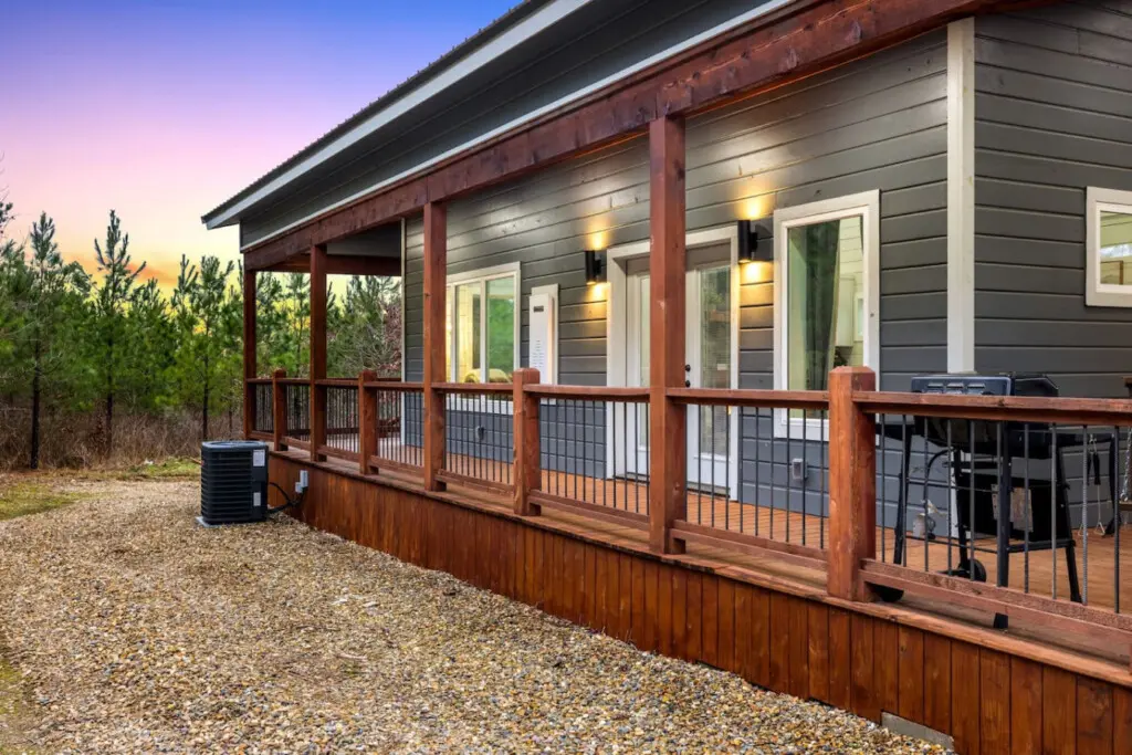 The covered porch wraps around this place like it was designed specifically for those golden-hour moments when the light hits just right and you can't imagine being anywhere else.