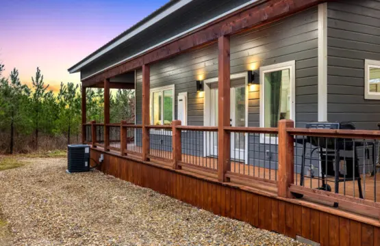 The covered porch wraps around this place like it was designed specifically for those golden-hour moments when the light hits just right and you can't imagine being anywhere else.