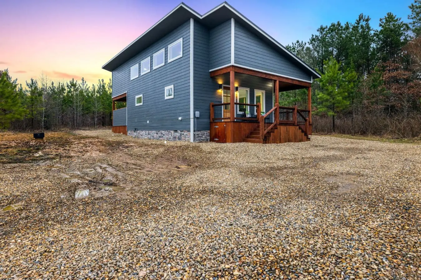 This modern cabin nestled in the pines is giving major "I never want to leave" energy—especially when you've got your own private slice of forest, a wraparound porch, and nothing but trees and sky in every direction.