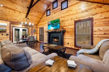 Features an open-concept layout with high ceilings and wood-paneled walls.