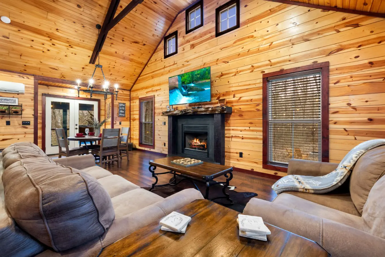 Features an open-concept layout with high ceilings and wood-paneled walls.