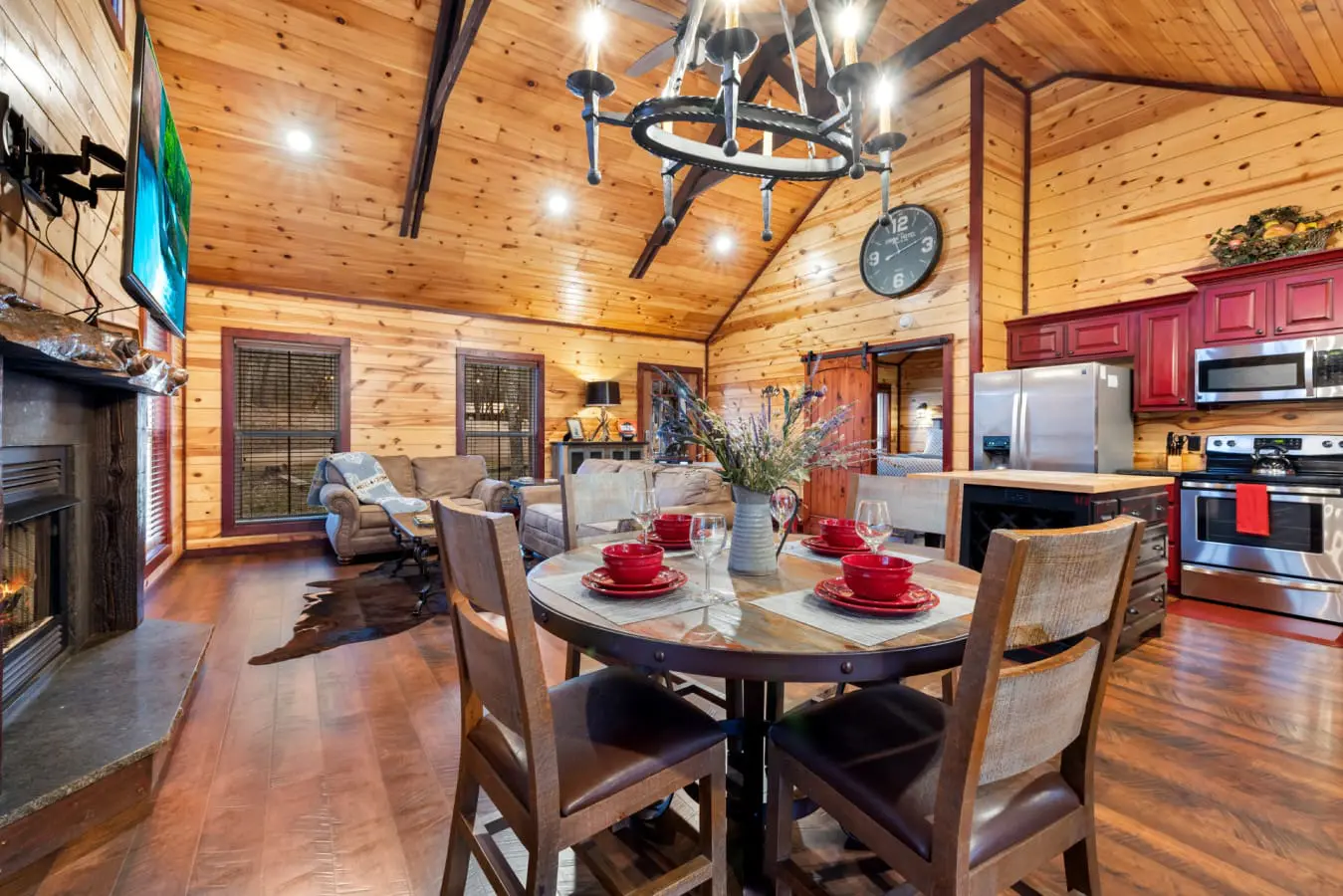 The perfect open-concept space for a relaxing getaway, featuring a full kitchen, dining area, and a cozy fireplace.