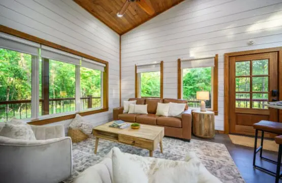 With windows framing the forest from practically every angle, this sunlit living room feels like you're basically hanging out inside the trees themselves.