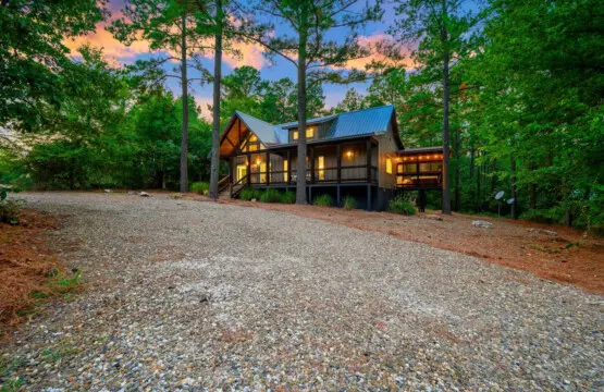 This gravel drive pulling up to those warm glowing windows nestled in the pines is basically that moment where you realize you've officially left the real world behind.