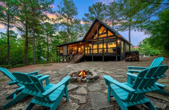Grab a seat by the fire pit with those Adirondack chairs and you've basically got the perfect setup for laughing with friends under the stars while the cabin glows behind you.