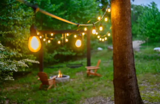 String lights are draped over the yard to provide warm lighting in the evening.