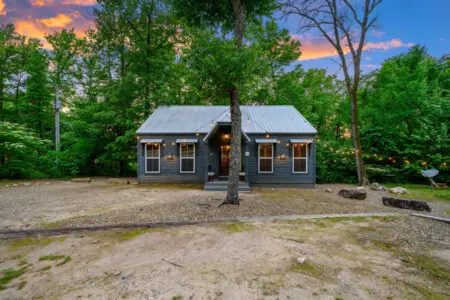 A warm and inviting front view welcoming you to your perfect cabin getaway surrounded by nature
