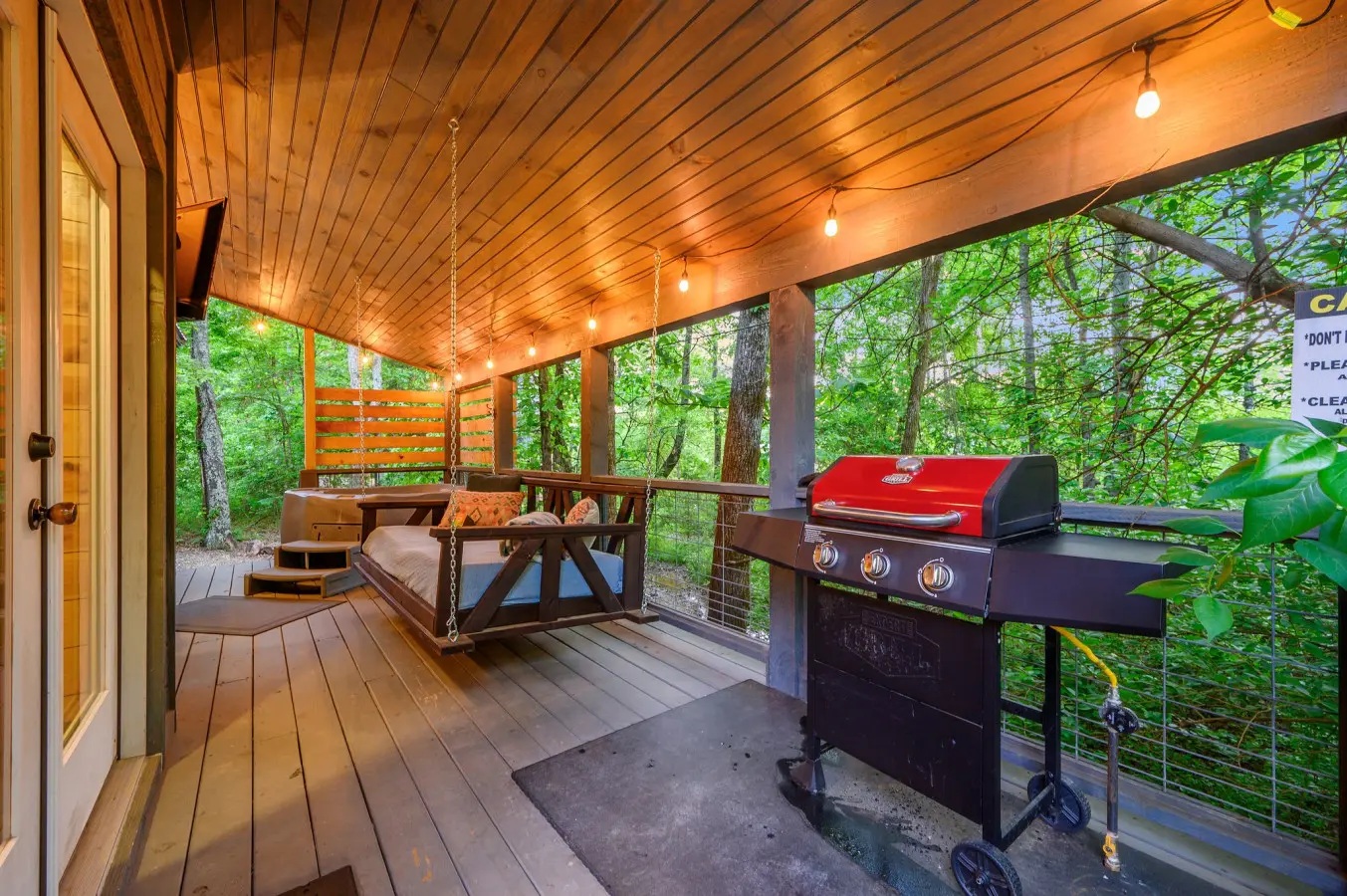 Spacious deck area with a grill, perfect for enjoying outdoor cooking and dining in a relaxing setting