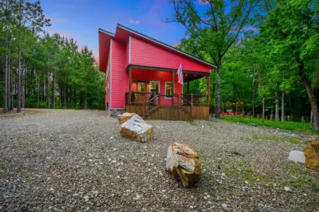 Pull up to this vivid red cabin nestled in the pines and you'll instantly get why it's called Lil Red—it's the kind of place that feels like your own private retreat the moment you step out of the car.