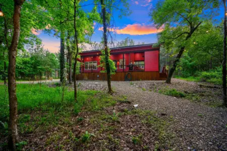 Pulled straight from a storybook with that vibrant red siding glowing against the deep green forest, Lil Red is the kind of place that makes you understand why people fall in love with cabins in the first place.