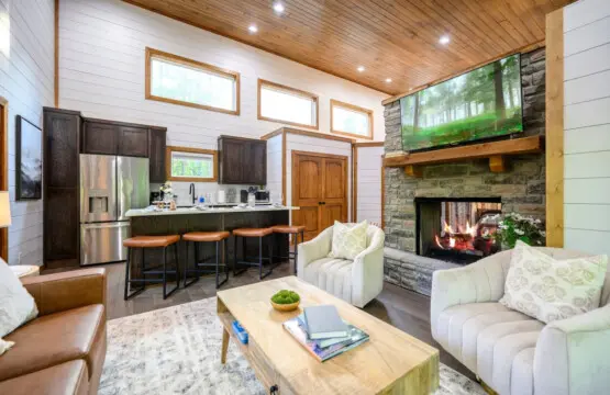The kitchen island is basically the social command center of this cabin—pull up a stool and you've got prime real estate for watching the fire, chatting with your crew, and keeping tabs on whatever's happening in the living room.