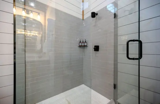 This walk-in shower is basically a no-fuss sanctuary where you can rinse off the day without any drama, complete with black fixtures that keep things looking sharp and clean.