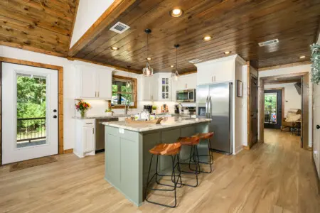 A cabin-kitchen-wood-ceiling-green-island.jpg