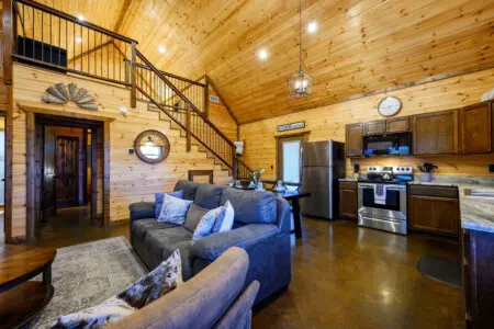 This open-concept cabin combines rustic wood charm with modern stainless steel appliances and a lofted layout perfect for groups.