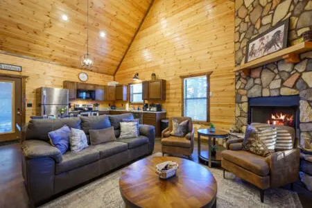 This cozy log cabin has everything you need with a stone fireplace, full kitchen, and comfortable seating for the whole crew.