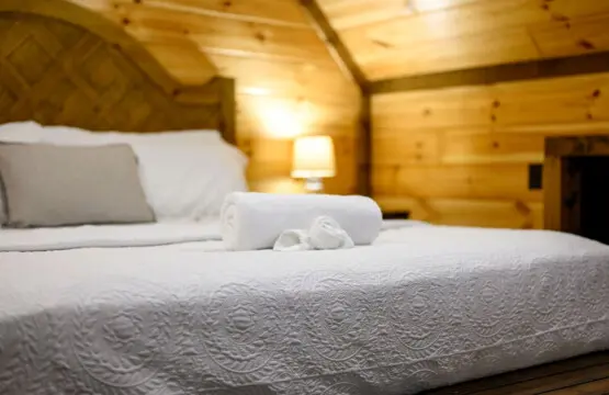 This cozy log cabin bedroom has all the rustic charm you need for a perfect mountain getaway.