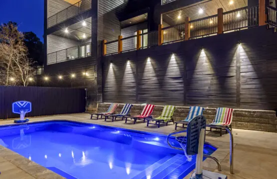 Night swims hit different when the pool glows blue and you've got colorful loungers waiting poolside.