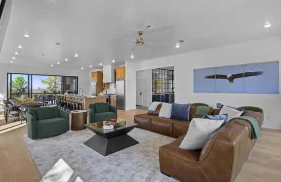 The leather sectional and those green swivel chairs make this living room perfect for spreading out with your crew.