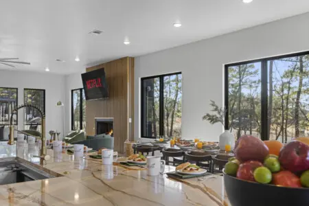 Marble counter, open kitchen, Netflix by the fireplace — this main level runs the whole crew.