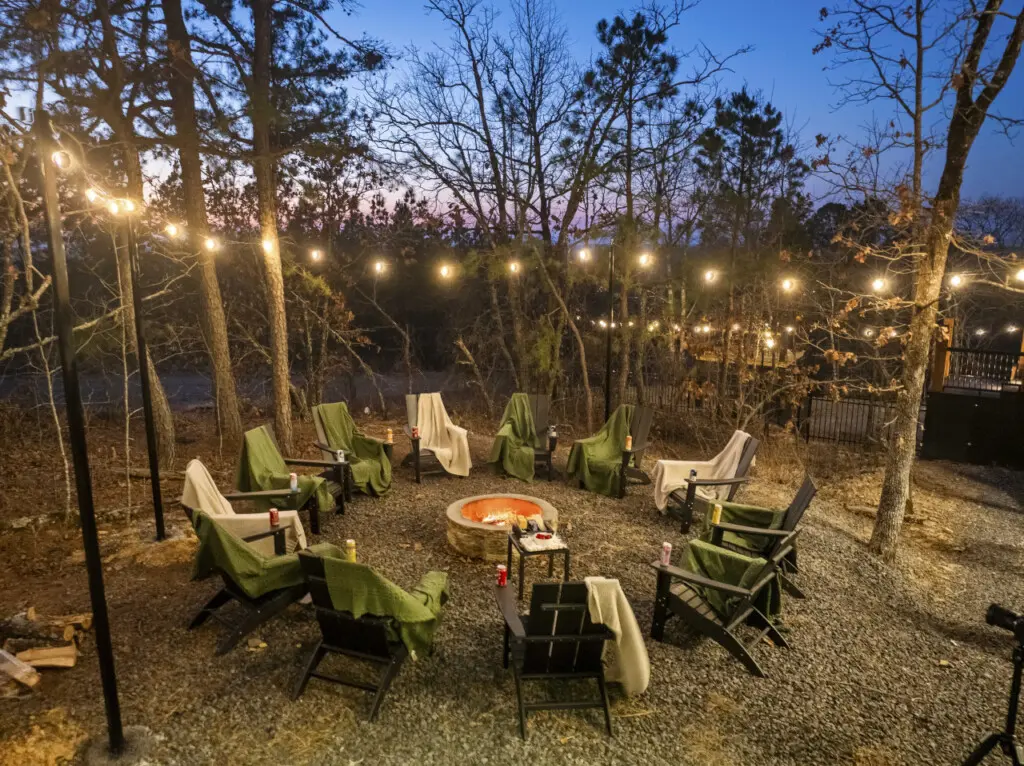 Blankets on every Adirondack chair around the fire pit because Broken Bow evenings get chilly, even with the flames going.