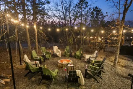 Blankets on every Adirondack chair around the fire pit because Broken Bow evenings get chilly, even with the flames going.