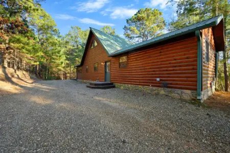 This beautiful log cabin nestled in the pines offers the perfect secluded retreat surrounded by towering forest.