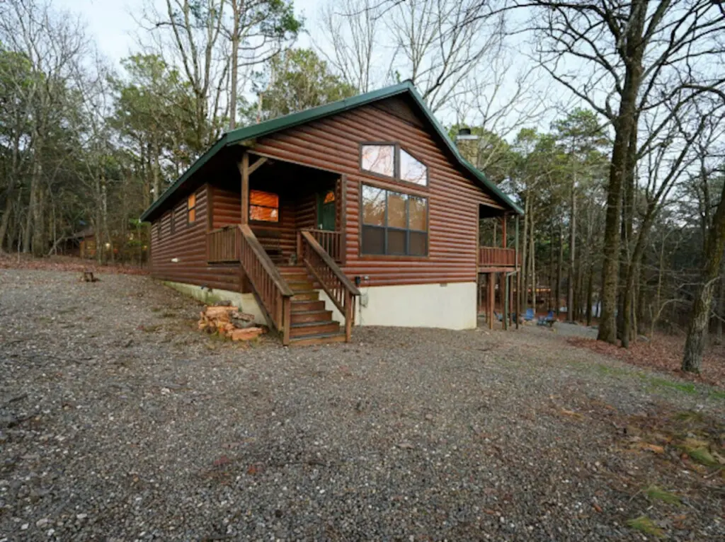 Cozy log cabin nestled in the woods with a spacious deck and plenty of natural light.