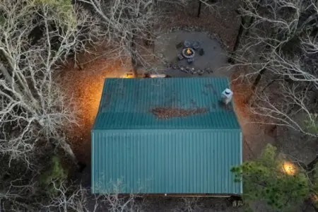 Cozy cabin nestled in the woods with a fire pit perfect for stargazing and unwinding in nature.