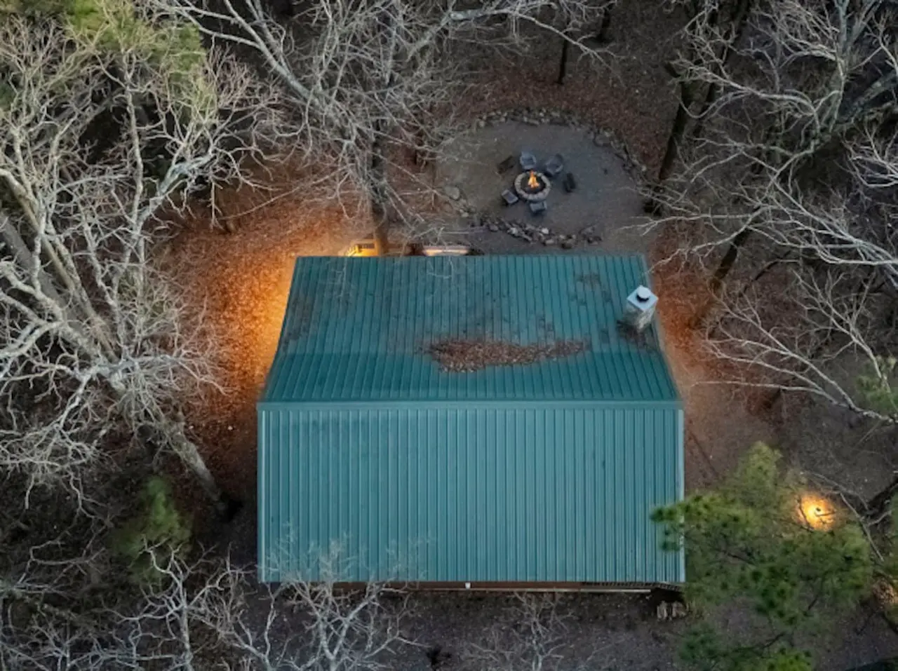 Cozy cabin nestled in the woods with a fire pit perfect for stargazing and unwinding in nature.