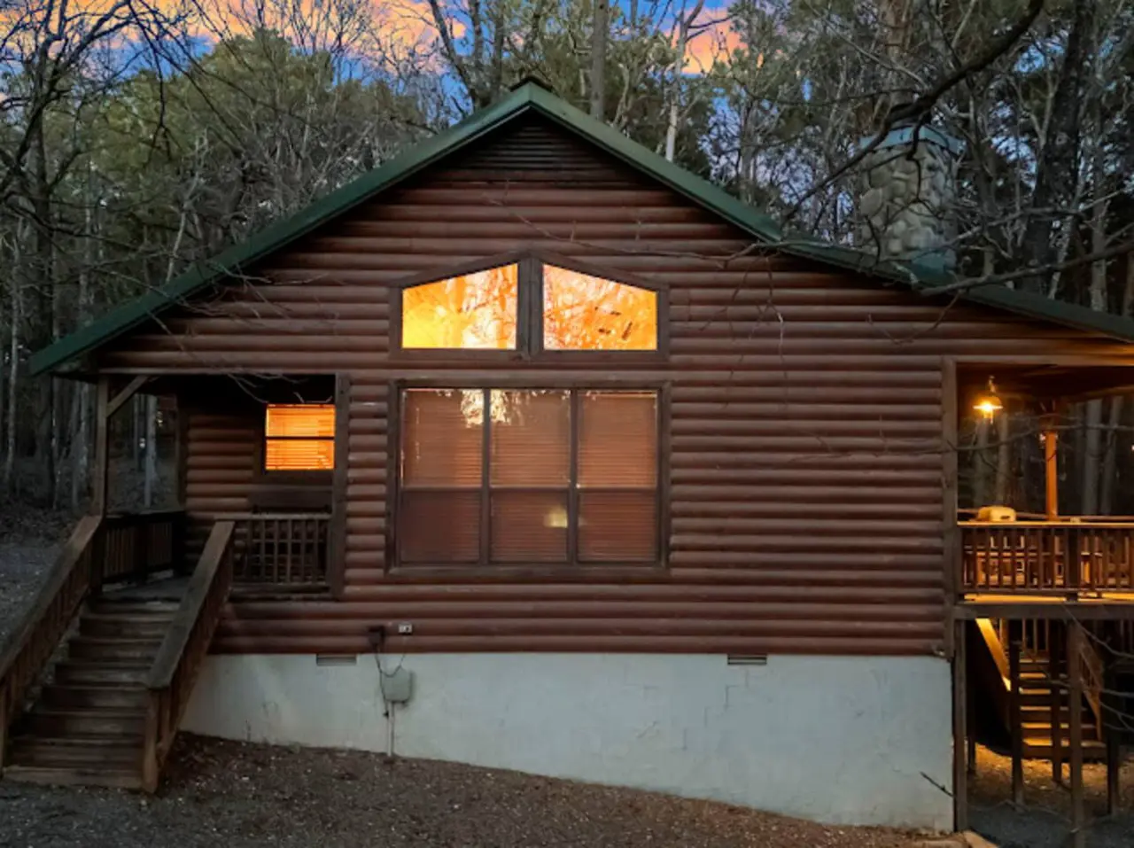 Cozy log cabin nestled in the woods with warm lighting and a peaceful forest setting perfect for a getaway.