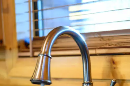 This modern kitchen sink has a sleek pulldown faucet with killer water views through the window.