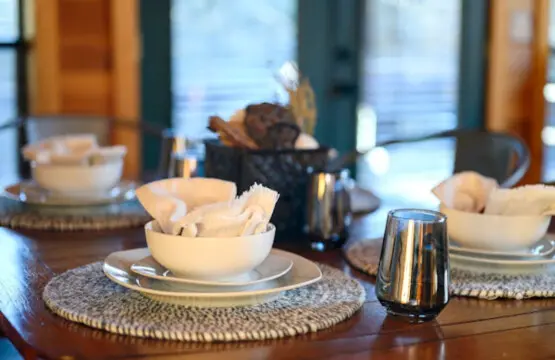 Stunning oceanfront dining room with floor-to-ceiling windows and refined coastal ambiance.