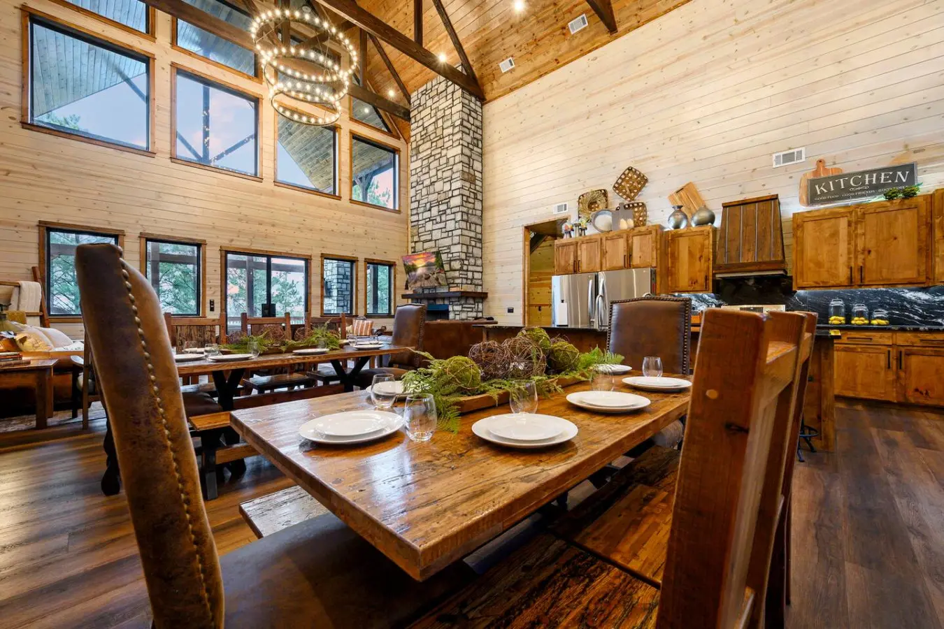 This open-concept cabin has soaring ceilings, a wood-burning fireplace, and walls of windows overlooking the trees.