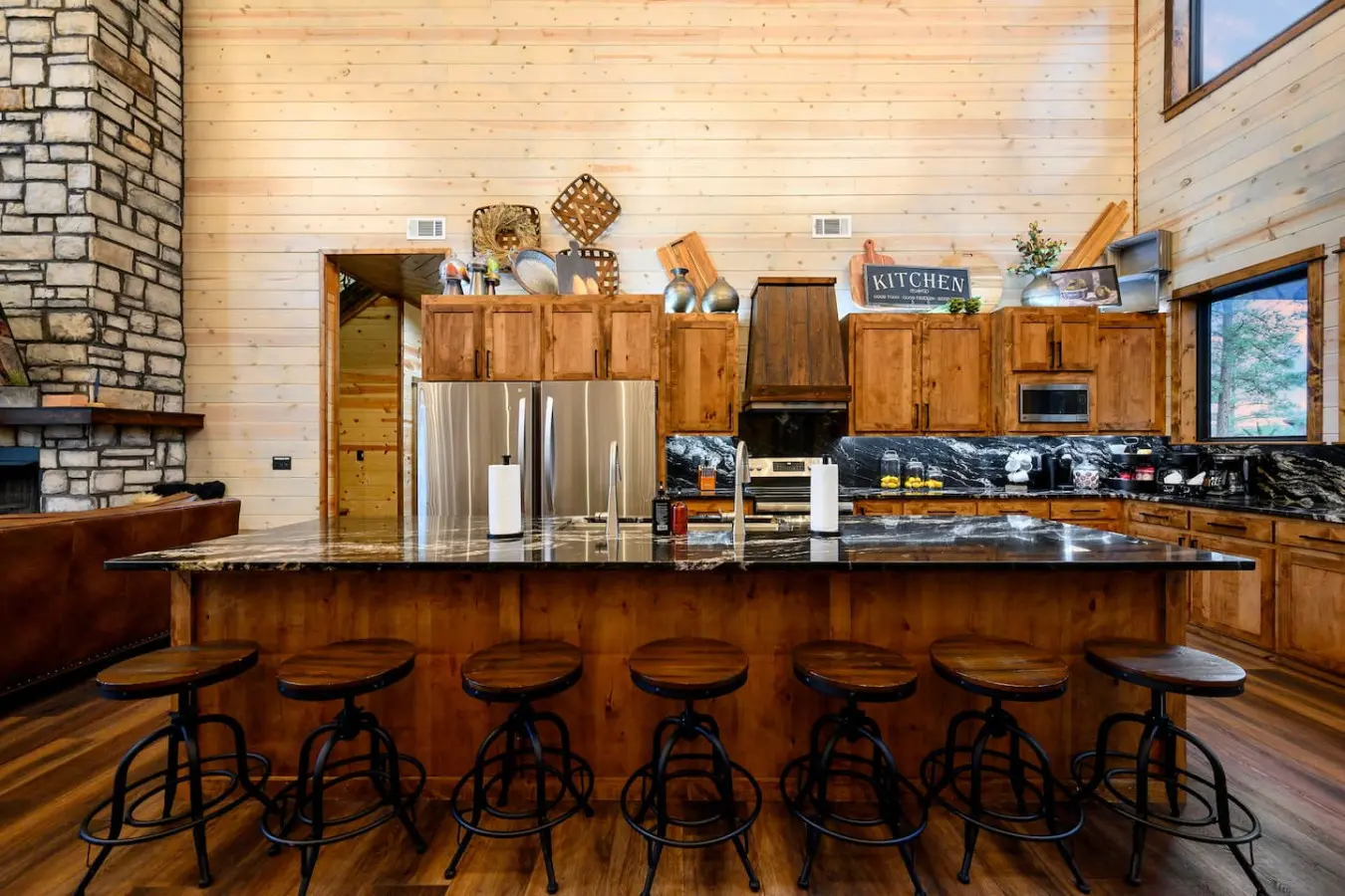 This gorgeous log cabin kitchen has an island that seats seven and flows into the open living space with those amazing views.