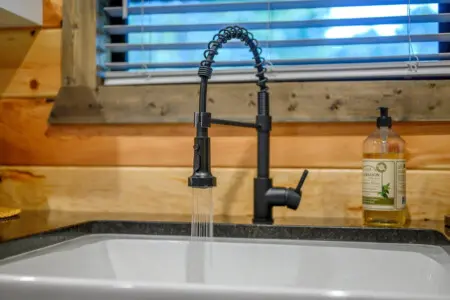 The sleek black faucet with that gorgeous spiral pull-down spout is basically all the kitchen upgrade energy you need to make cooking feel way more enjoyable.