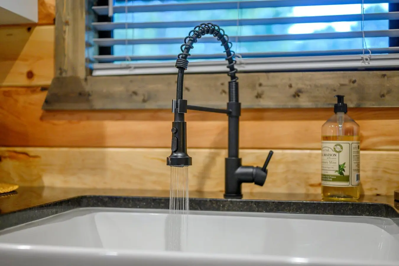 The sleek black faucet with that gorgeous spiral pull-down spout is basically all the kitchen upgrade energy you need to make cooking feel way more enjoyable.