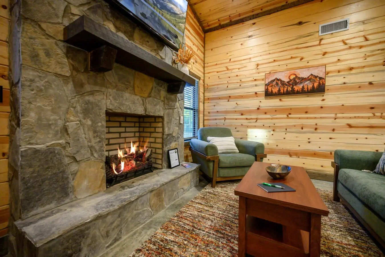 This stone fireplace is basically begging you to sink into one of those green chairs and just zone out for a while.