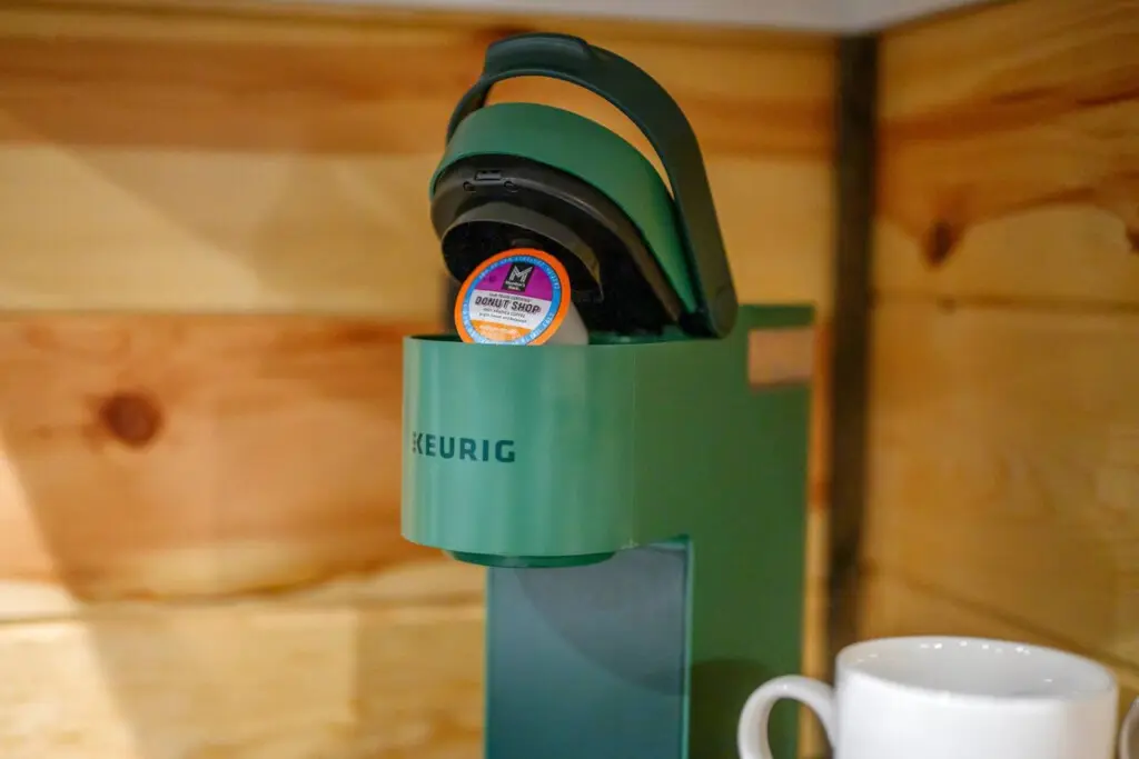 This cute little Keurig setup tucked into the cabin's nook proves that even the coziest getaways need their coffee fix.