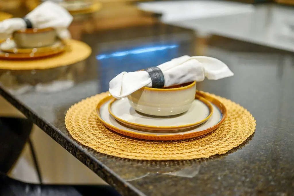 The elegant table settings with those crisp white linens and gold accents definitely set the mood for some seriously memorable dinners at this place.